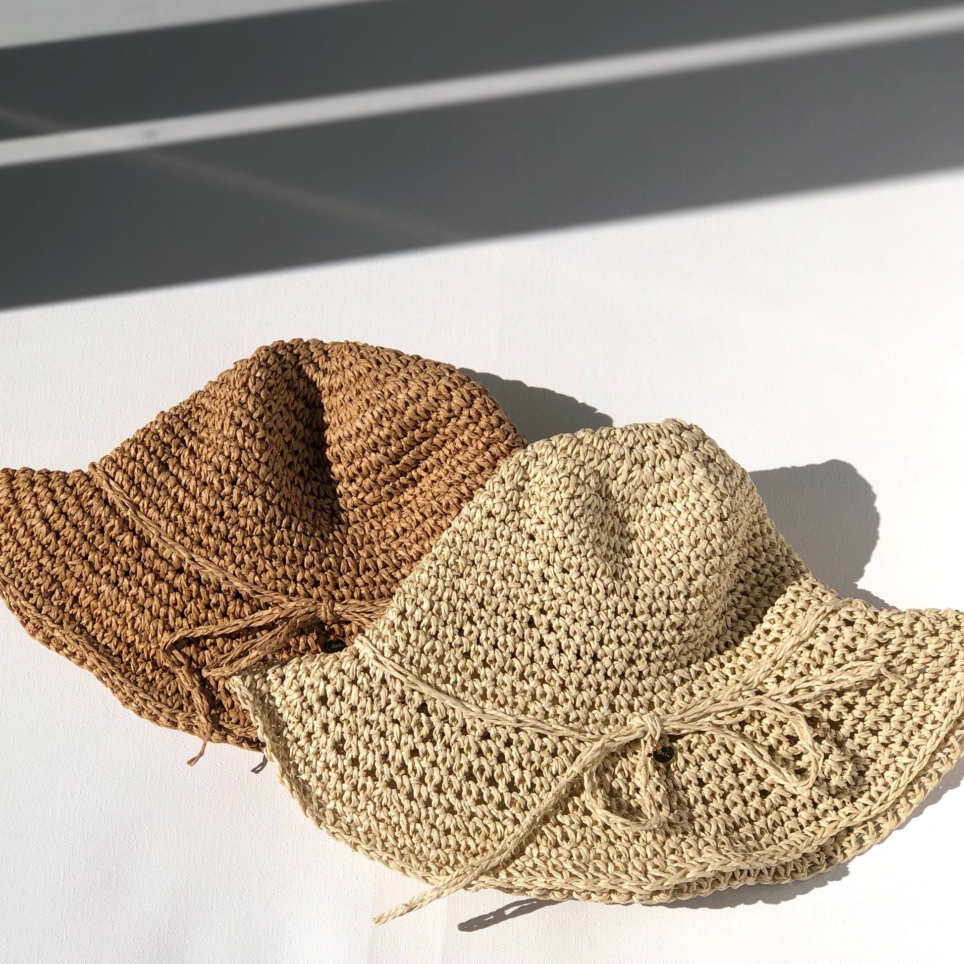 mum and mini straw hats in natural and light tones